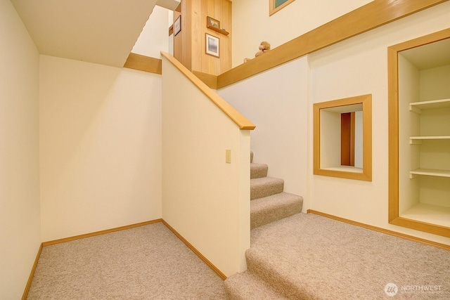 17147 Hope Island Ln, La Conner, WA 98257 - staircase featuring carpet flooring, baseboards, and built in features