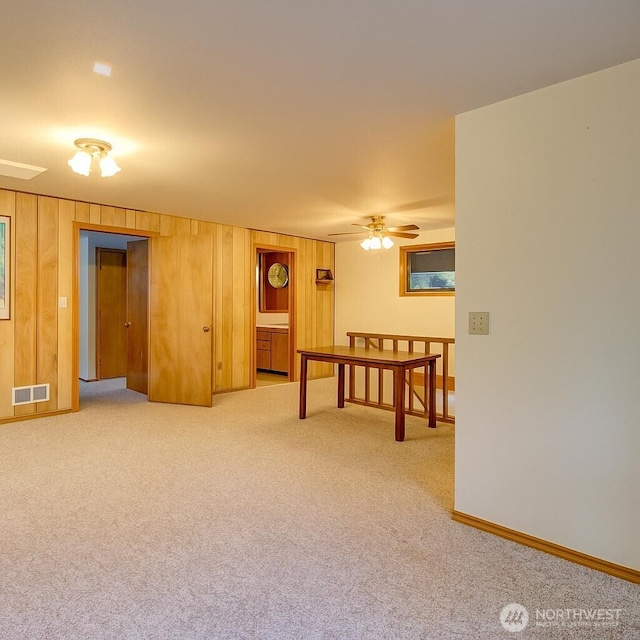 17147 Hope Island Ln, La Conner, WA 98257 - carpeted empty room featuring wooden walls, ceiling fan, and baseboards