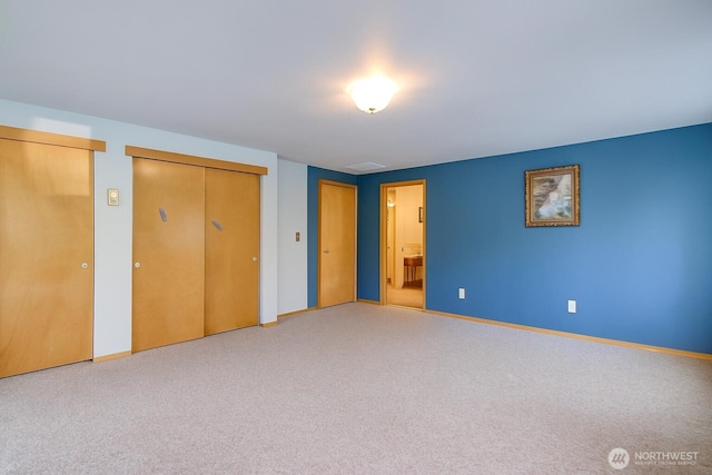 17147 Hope Island Ln, La Conner, WA 98257 - unfurnished bedroom featuring two closets, baseboards, and ensuite bathroom
