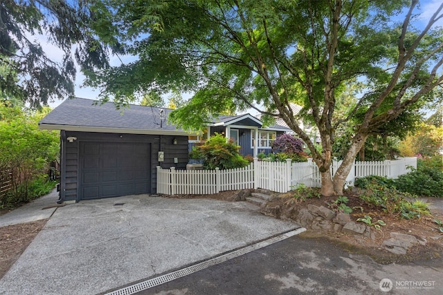 1716 N 125th St, Seattle, WA 98133 - view of front of home featuring a fenced front yard, concrete driveway, roof with shingles, and an attached garage