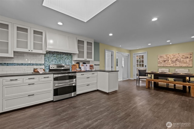 1716 N 125th St, Seattle, WA 98133 - kitchen with range with two ovens, dark countertops, white cabinetry, tasteful backsplash, and recessed lighting