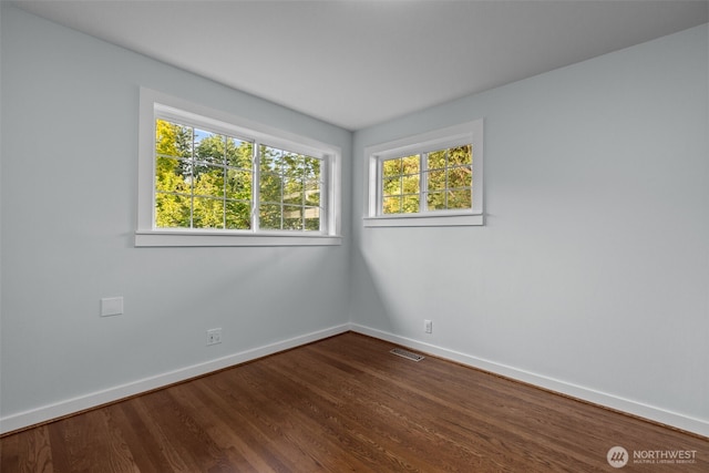 1716 N 125th St, Seattle, WA 98133 - spare room featuring baseboards and dark wood finished floors