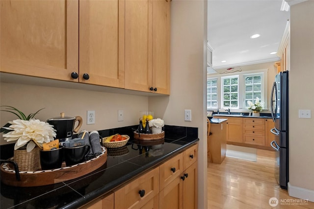 2315 35th Ct, Anacortes, WA 98221 - kitchen with freestanding refrigerator, light wood finished floors, crown molding, light brown cabinetry, and dark countertops