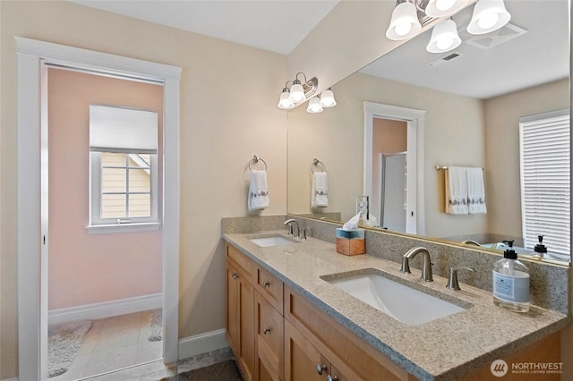2315 35th Ct, Anacortes, WA 98221 - bathroom featuring double vanity, a chandelier, and baseboards
