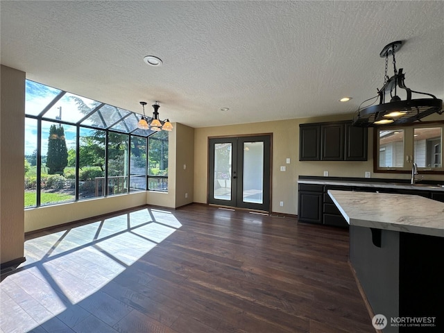 164 Harkins Rd, Winlock, WA 98596 - kitchen featuring a textured ceiling, light countertops, a sink, dark wood-style floors, and dark cabinetry