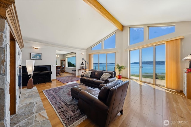 2364 Strawberry Point Rd, Oak Harbor, WA 98277 - living area with a water view, beam ceiling, light wood-style floors, and high vaulted ceiling