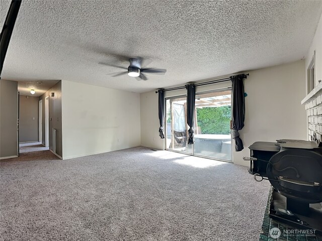 17103 15th Ave E, Spanaway, WA 98387 - unfurnished living room featuring a ceiling fan, carpet flooring, a textured ceiling, and a fireplace