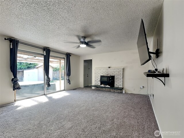 17103 15th Ave E, Spanaway, WA 98387 - unfurnished living room featuring ceiling fan, carpet flooring, a textured ceiling, and a brick fireplace