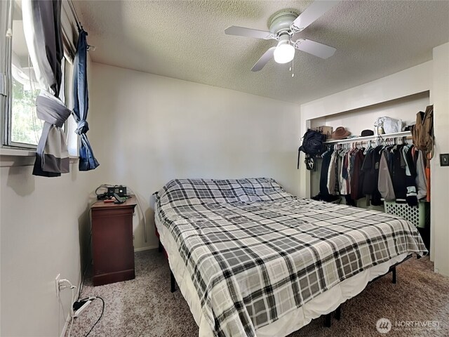 17103 15th Ave E, Spanaway, WA 98387 - carpeted bedroom featuring a closet, a textured ceiling, and ceiling fan