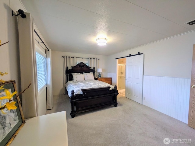 201 Union Ave SE Unit 188, Renton, WA 98059 - bedroom featuring wainscoting, a barn door, carpet, and connected bathroom