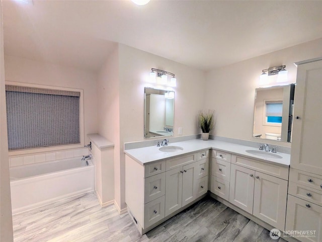 201 Union Ave SE Unit 188, Renton, WA 98059 - full bath featuring wood finished floors, double vanity, a garden tub, and baseboards
