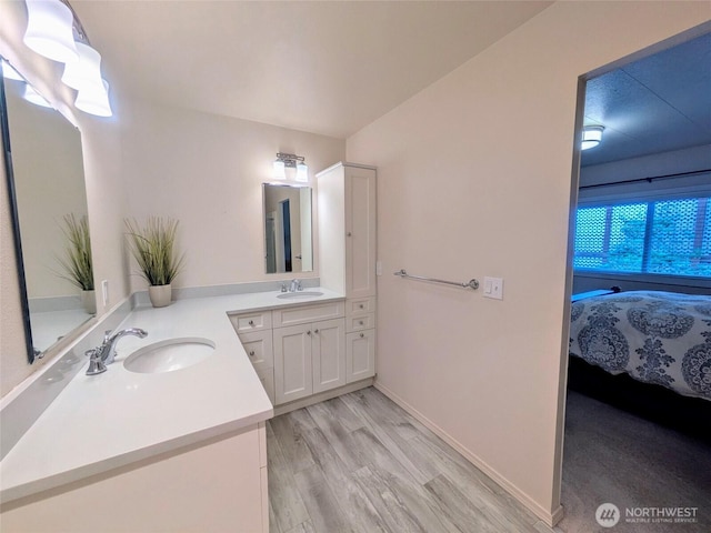 201 Union Ave SE Unit 188, Renton, WA 98059 - bathroom featuring vanity, connected bathroom, wood finished floors, and baseboards