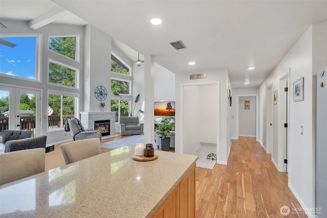 521 E Enchantment Dr, Union, WA 98592 - kitchen featuring light wood-style floors, a glass covered fireplace, light stone countertops, recessed lighting, and baseboards