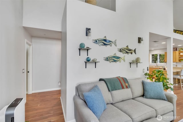 521 E Enchantment Dr, Union, WA 98592 - living area with wood finished floors, a high ceiling, baseboards, and recessed lighting