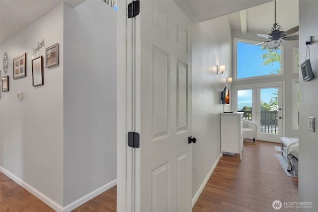 521 E Enchantment Dr, Union, WA 98592 - hall featuring baseboards, wood finished floors, a towering ceiling, and beam ceiling