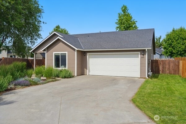 252 NW Ruby Ln, College Place, WA 99324 - ranch-style house with concrete driveway and an attached garage