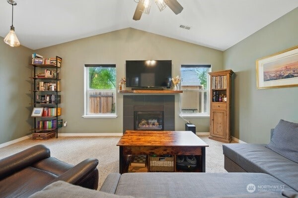 252 NW Ruby Ln, College Place, WA 99324 - carpeted living area featuring ceiling fan, vaulted ceiling, a fireplace, and baseboards