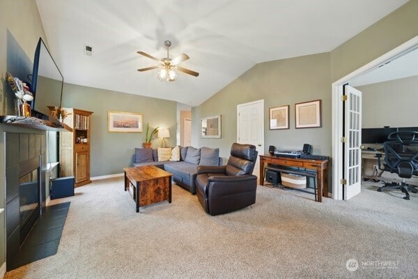 252 NW Ruby Ln, College Place, WA 99324 - living room with a desk, carpet flooring, a tile fireplace, a ceiling fan, and vaulted ceiling