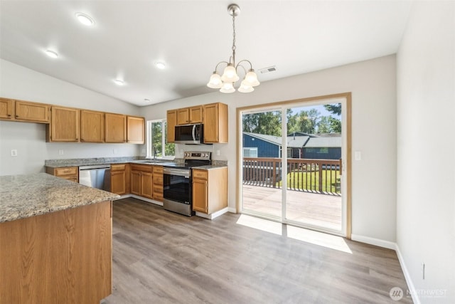 324 E 48th Street Dr, Tacoma, WA 98404 - kitchen featuring appliances with stainless steel finishes, a sink, a chandelier, pendant lighting, and plenty of natural light