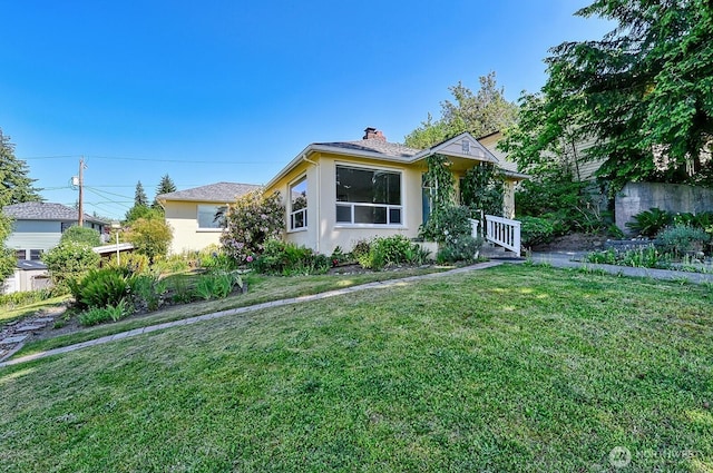 1160 St Paul St, Bellingham, WA 98229 - bungalow-style home featuring stucco siding, a chimney, and a front yard