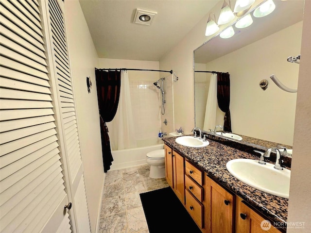 31500 33rd Pl SW Unit H101, Federal Way, WA 98023 - bathroom featuring shower / bath combination with curtain, double vanity, toilet, a closet, and stone finish flooring