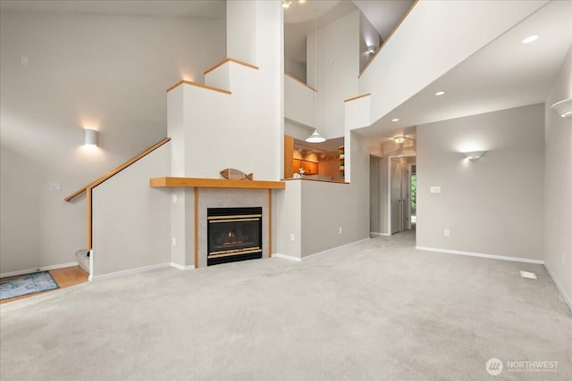9008 NE 54th St Unit A3, Vancouver, WA 98662 - unfurnished living room with stairs, carpet flooring, and a tile fireplace
