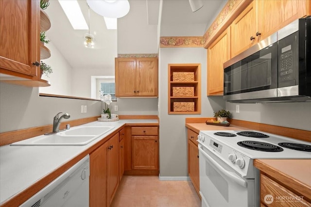 9008 NE 54th St Unit A3, Vancouver, WA 98662 - kitchen with white appliances, a skylight, light countertops, and light tile patterned flooring
