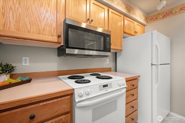 9008 NE 54th St Unit A3, Vancouver, WA 98662 - kitchen with white appliances, light countertops, and light brown cabinetry