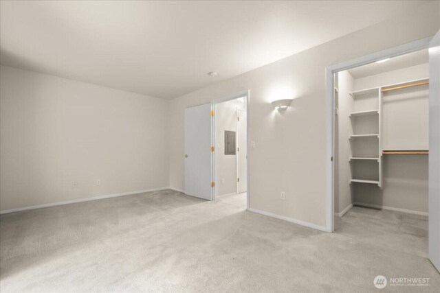 9008 NE 54th St Unit A3, Vancouver, WA 98662 - unfurnished bedroom featuring light colored carpet, electric panel, a walk in closet, and a closet