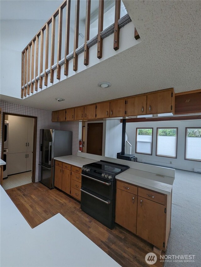 24 Nancy Ln, Copalis Beach, WA 98535 - kitchen featuring double oven range, stainless steel fridge, brown cabinetry, light countertops, and dark wood finished floors