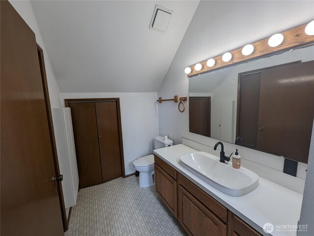 24 Nancy Ln, Copalis Beach, WA 98535 - bathroom featuring lofted ceiling, vanity, and toilet