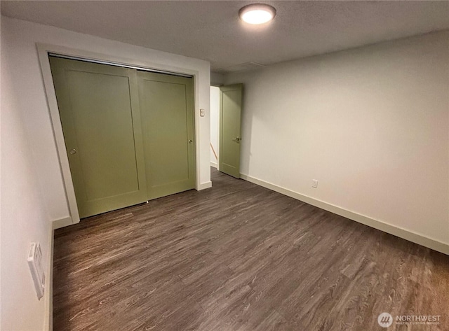 24 Nancy Ln, Copalis Beach, WA 98535 - unfurnished bedroom with baseboards, dark wood-style flooring, and a closet