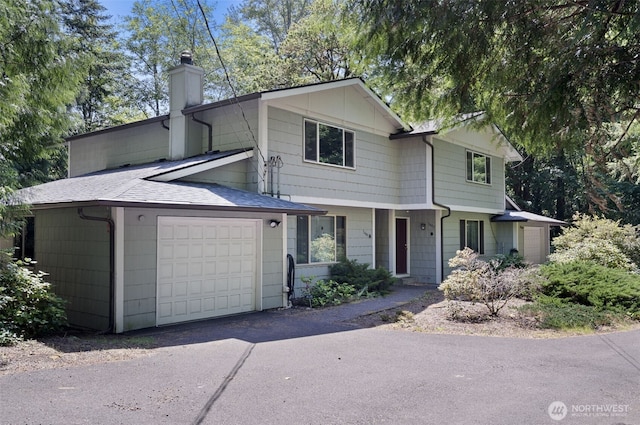 3407 56th St NW, Gig Harbor, WA 98335 - view of front of house featuring a chimney, an attached garage, a shingled roof, and driveway