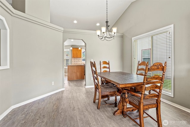 2321 52nd Ave, Longview, WA 98632 - dining area featuring arched walkways, a chandelier, wood finished floors, baseboards, and recessed lighting