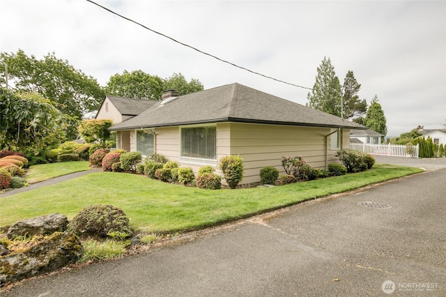 809 N K St, Aberdeen, WA 98520 - view of side of home with a chimney and roof with shingles