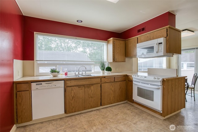 809 N K St, Aberdeen, WA 98520 - kitchen featuring white appliances, a sink, light countertops, and brown cabinets