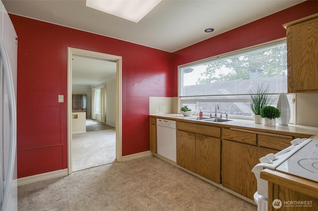 809 N K St, Aberdeen, WA 98520 - kitchen featuring white appliances, a sink, light countertops, brown cabinets, and baseboards