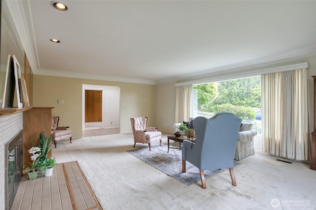 809 N K St, Aberdeen, WA 98520 - living room featuring crown molding, a fireplace, and light carpet