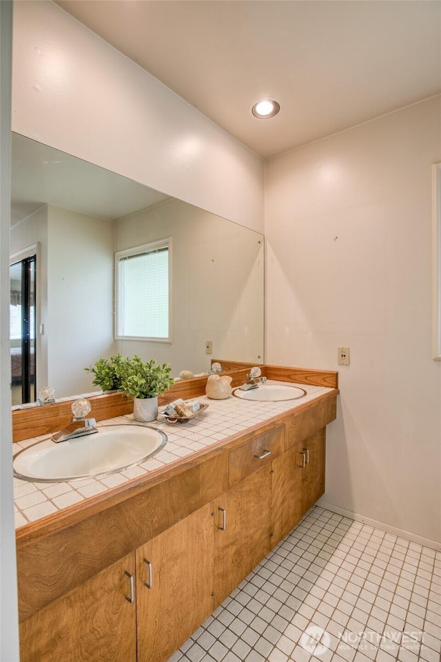 809 N K St, Aberdeen, WA 98520 - bathroom featuring double vanity, tile patterned flooring, and baseboards