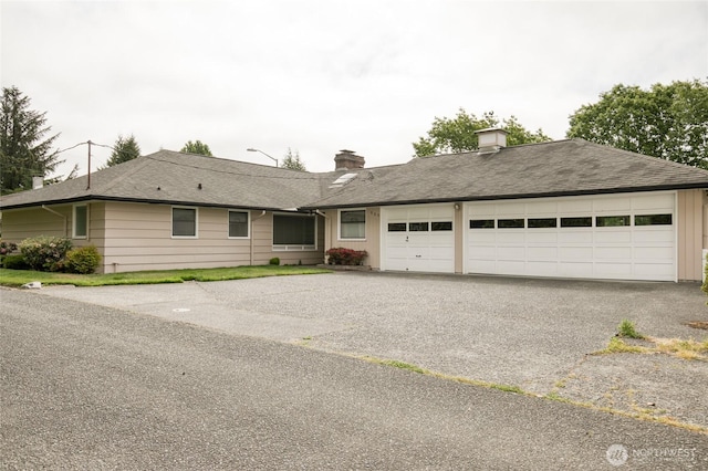 809 N K St, Aberdeen, WA 98520 - ranch-style house featuring a garage, a chimney, and asphalt driveway
