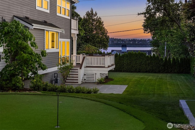 6006 SE 30th St, Mercer Island, WA 98040 - yard at dusk featuring an area to practice putting, a yard, a wooden deck, and stairway