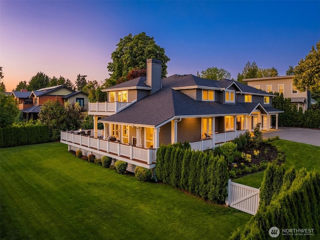 6006 SE 30th St, Mercer Island, WA 98040 - back of property at dusk featuring a porch, a chimney, asphalt driveway, and a balcony
