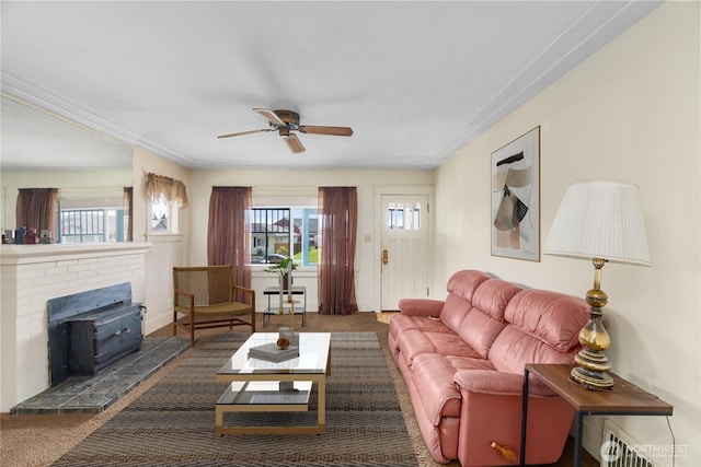 504 W 4th St, Aberdeen, WA 98520 - carpeted living room featuring ceiling fan, a wood stove, and baseboards
