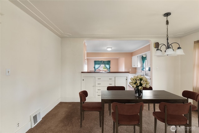 504 W 4th St, Aberdeen, WA 98520 - dining space with dark colored carpet, a chandelier, and baseboards