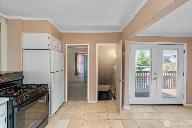 504 W 4th St, Aberdeen, WA 98520 - kitchen with black gas stove, french doors, ornamental molding, white cabinets, and light tile patterned flooring