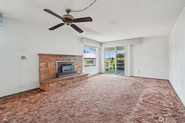 32427 6th Ave, Black Diamond, WA 98010 - unfurnished living room with ceiling fan, carpet flooring, a textured ceiling, and a fireplace with raised hearth