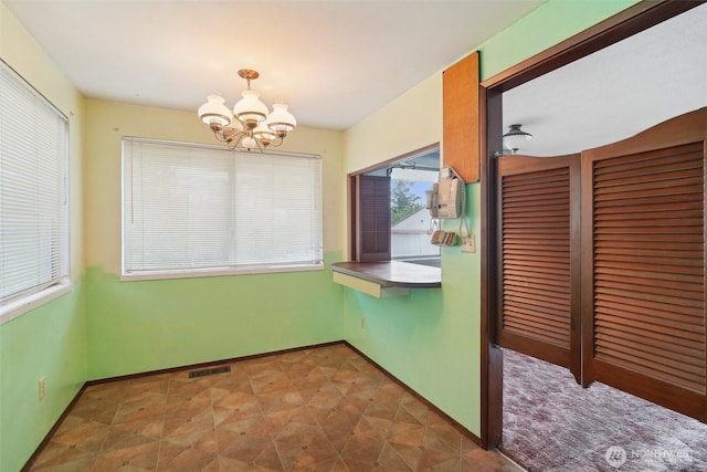 32427 6th Ave, Black Diamond, WA 98010 - unfurnished dining area featuring a chandelier and baseboards