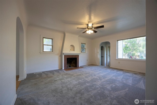 1030 N Clinton St, Walla Walla, WA 99362 - unfurnished living room with a ceiling fan, arched walkways, plenty of natural light, and carpet flooring