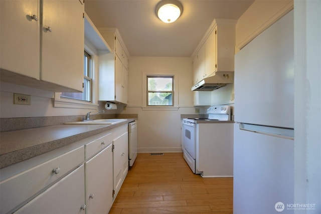 1030 N Clinton St, Walla Walla, WA 99362 - kitchen with white appliances, a sink, under cabinet range hood, baseboards, and white cabinets