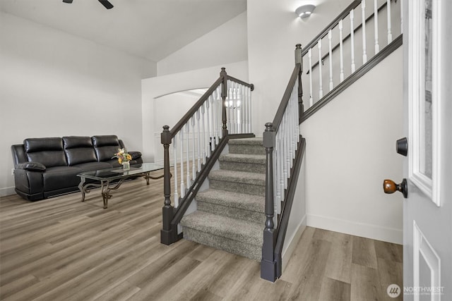 13901 Cedar Ct, Sultan, WA 98294 - stairs with wood finished floors, baseboards, a ceiling fan, and high vaulted ceiling